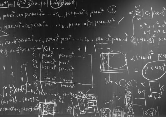 Image of blackboard with algorithms written all over it.