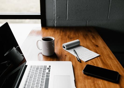 Picutre of a computer and cup on a table