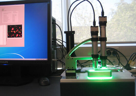 The automated pollen locator and counter, Classifynder, with part of a computer screen showing the output