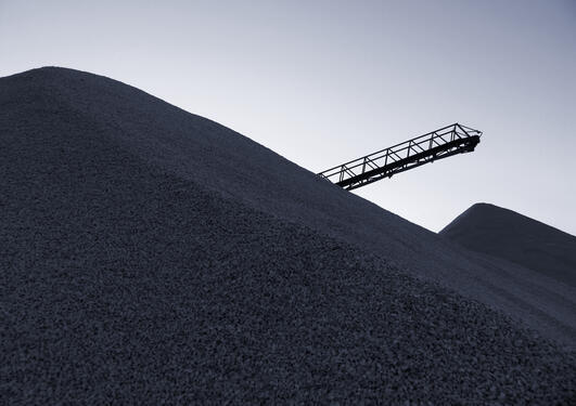 Belt conveyor and loads of coal at the harbor quay