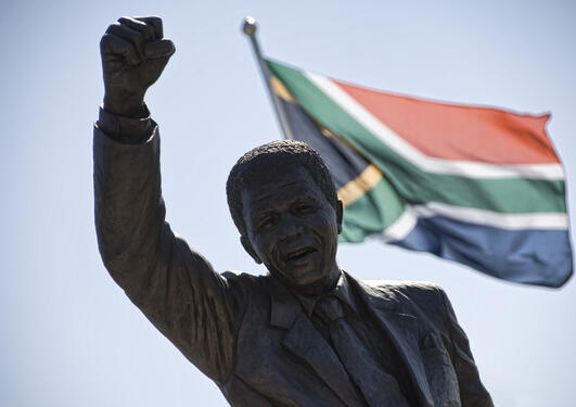 A statue of Nelson Mandela in front of the South African flag, used to accompany article on a democracy conference in Johannesburg 17-19 November 2014.