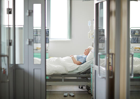 eldre kvinne ligger alene på sykehus