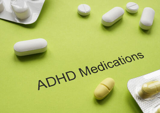 Green sheet of paper with an inscription ADHD medications and pills.