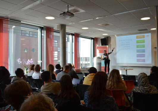 Audience attending seminar listening to presentation