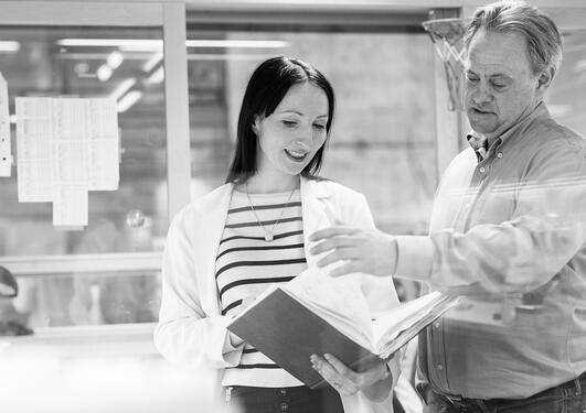 Agnete Engelsen and James Lorens involved in lab work.