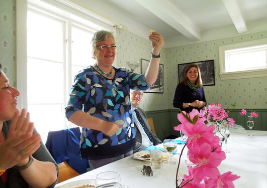 Anne, Hilary holding up a tiny polar bear, John, and Kathy at dinner at Blondehuset