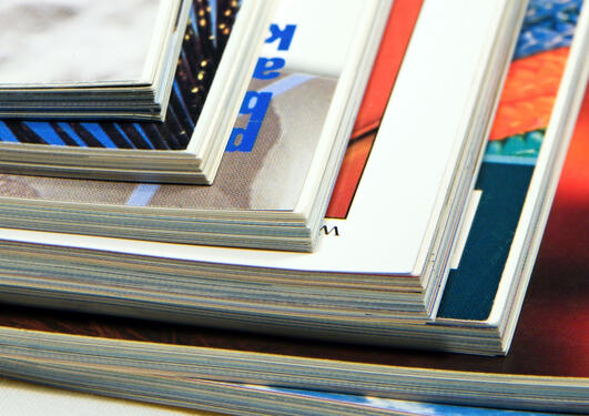 A stack of journals on a table.