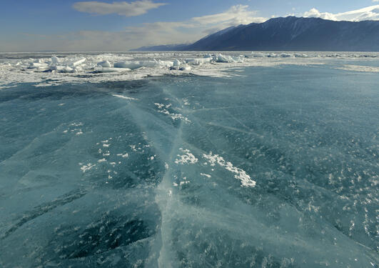 Endless blue ice on the frozen lake Baikal, Siberia, Russia, used to illustrate side event at UN on climate action.