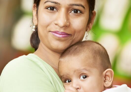 Illustration photo of Indian mother holding her child.