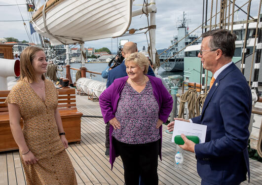 Student Thea Båtevik and Rector Dag Rune Olsen from the University of Bergen with Norway's Prime Minister Erna Solberg at the launch of the One Ocean Expedition on board tall ship Statsraad Lehmkuhl.