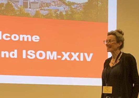 a man and woman in front of a presentation