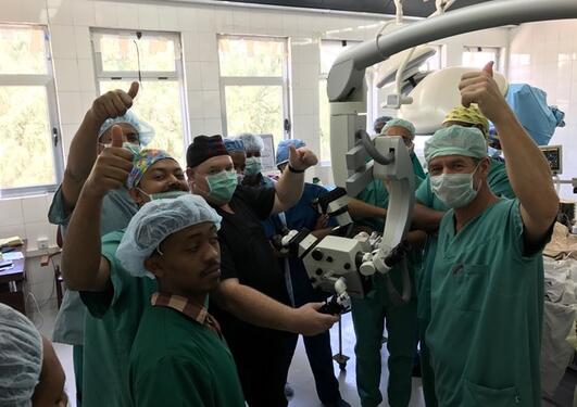 Neuro surgery team with new microscope