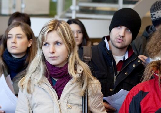 Five international students standing looking in the same direction