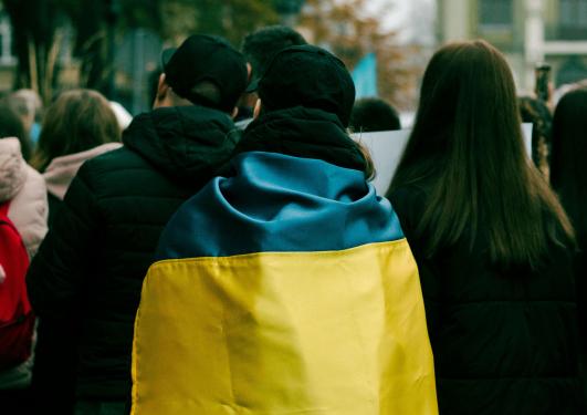 Person wrapped in Ukrainian flag