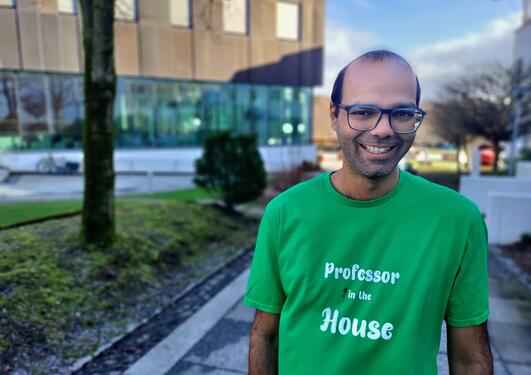 Siddharth Sareen smiling at the camer with t shirt saying Professor in the house