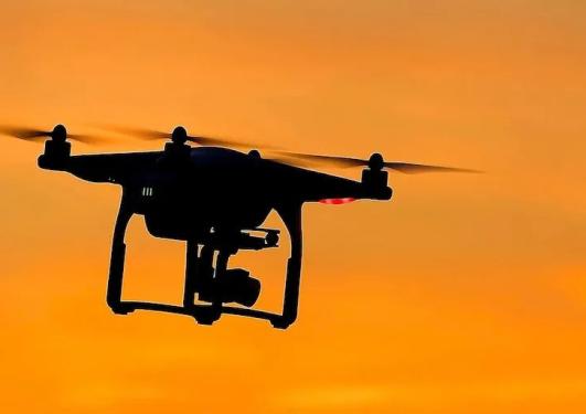 En drone med en oransjefarget himmel i bakgrunnen