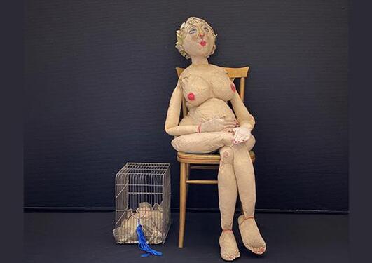 A textile sculpture of a woman