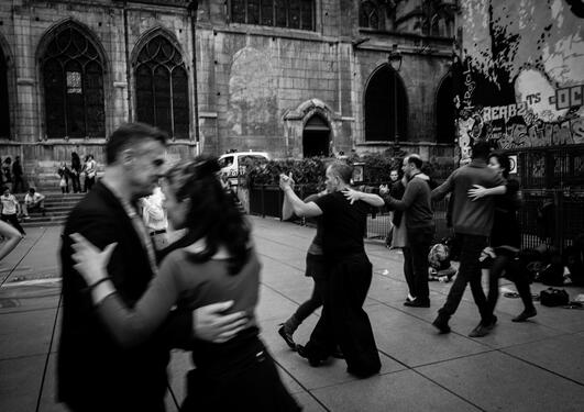 Black and white photo of several couples dancing tango