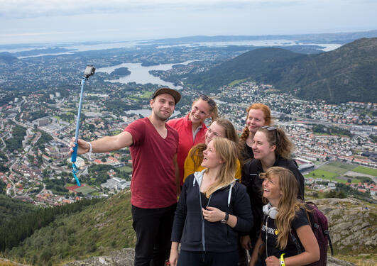 A group of students taking a selfie on top of Mount Ulriken